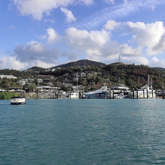 The Yacht Yard, Airlie Beach, with yachts against a tall mountain