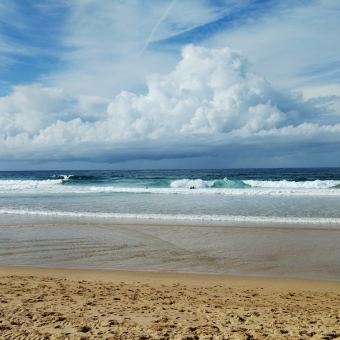 Storm Over The Horizon, Maroubra Beach, Maroubra, with yellow sand leading to whitewash water in front of crashing waves and bluest water all below a large brewing storm in the sky swarming from the horizon