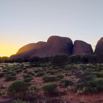 Kata Tjuṯa, Sunrise from Sunset Viewing Area, with a thick sunray streaming through one of the many heads of the rock formation